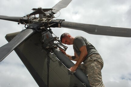 Army Spc. Anthony Maurer, 1st Battalion, 228th Aviation Regiment, inspects the tail pylon of his UH-60 Blackhawk for cracks during a 40-hour inspection May 15.  Specialist Maurer is a Blackhawk mechanic and crew chief assigned to one of two Joint Task Force-Bravo Blackhawk crews in Nicaragua this week to fly medics and equiment to two remote villages for medical readiness exercises.  (U.S. Air Force photo/Tech. Sgt. Rebecca Danét)