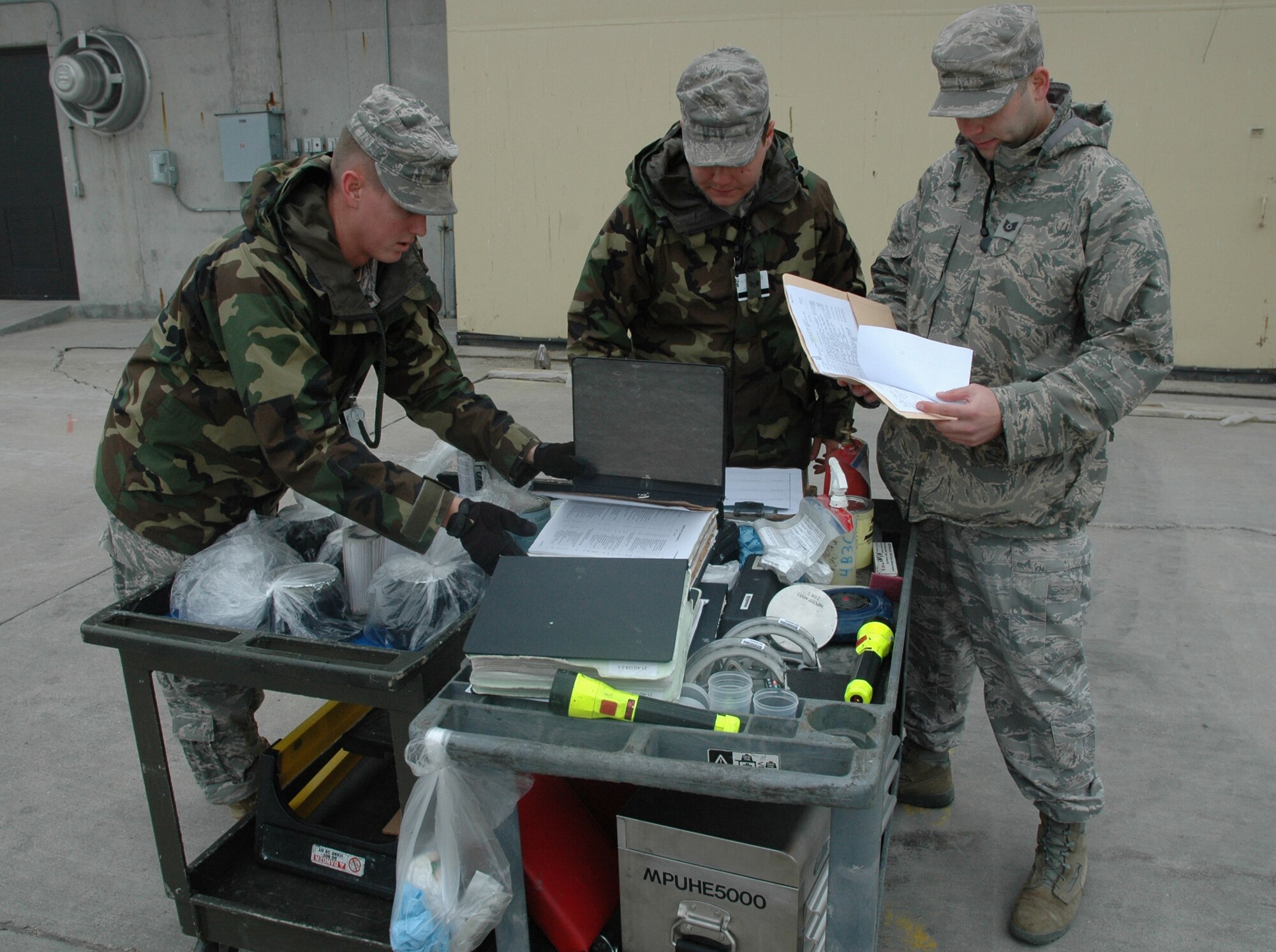 MINOT AIR FORCE BASE, N.D. -- (from left) Senior Airman Brandon Aguilar, Senior Airman Randolph McReynolds and Tech. Sgt. Carl Smithson, all of the 5th Munitions Squadron, inspect their tool cart during an Nuclear Surety Inspection here, May 15. An NSI is designed to evaluate a unit's readiness to execute nuclear operations. Areas to be evaluated during the NSI include operations, maintenance, security, and support activities needed to ensure the wing performs its mission in a safe, secure and reliable manner. This no-notice inspection is expected to conclude May 22. (U.S. Air Force photo by Senior Airman Wesley Wright)