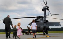 MOODY AIR FORCE BASE, Ga. -- Col. Kenneth Todorov, 23rd Wing commander, walks out to an HH-60G Pave Hawk helicopter with his children to thank aircrew members after his last flight as the base commander here May 14. Colonel Todorov’s next assignment will be at U.S. Northern Command at Peterson Air Force Base, Colo. (U.S. Air Force photo by Senior Airman Gina Chiaverotti)