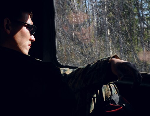 Marine Sgt. Ray Conard looks out the window May 14 at the Pacific Alaskan Range Complex. Marines are training with Airmen to provide enough manning to safely practice clearing the range of live munitions left over from Red Flag training operations. Sergeant Conard is with the 1st Explosive Ordnance Disposal, Camp Pendleton, Calif. (U.S. Air Force photo/Airman 1st Class Laura Max) 