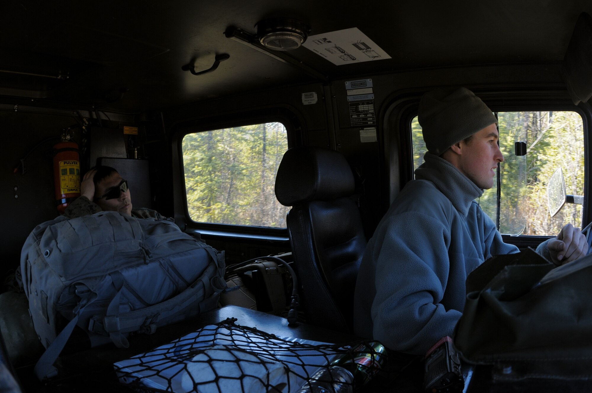 Airman 1st Class Brandon Wood navigates through a trail while Marine Sergeant Ray Conard watches from the backseat May 14, 2009, Pacific Alaskan Range Complex.  Training down range provides practice for disposing of live munitions which teaches safety techniques and hones their skills. Airman 1st Class Wood is with the 354th Civil Engineering Squadron Explosive Ordnance Flight and Sergeant Conard is with the 1st Explosive Ordnance Disposal Camp, Pendleton, Calif.  (U.S. Air Force photo/Airman 1st Class Laura Max)