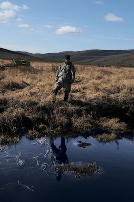 Senior Airman Matthew Leatherman surveys a pond for unexploded ordnance May 14 at the Pacific Alaskan Range Complex. The range is being searched for live munitions left over from Red Flag training operations which will later be disposed of. Airman Leatherman is with the 354th Civil Engineering Squadron Explosive Ordnance Flight. (U.S. Air Force photo/Airman 1st Class Laura Max) 