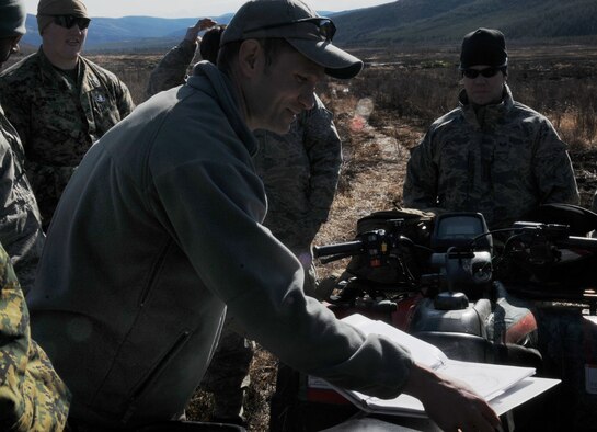 Senior Master Sgt. Albert Schneider gives a quick brief May 14 at the Pacific Alaskan Range Complex. The Airmen and Marines are clearing the range of live munitions after several Red Flag operations. Sergeant Schneider is with the 354th Civil Engineering Squadron Explosive Ordnance Flight at Eielson Air Force Base, Alaska. (U.S. Air Force photo/Airman 1st Class Laura Max) 
