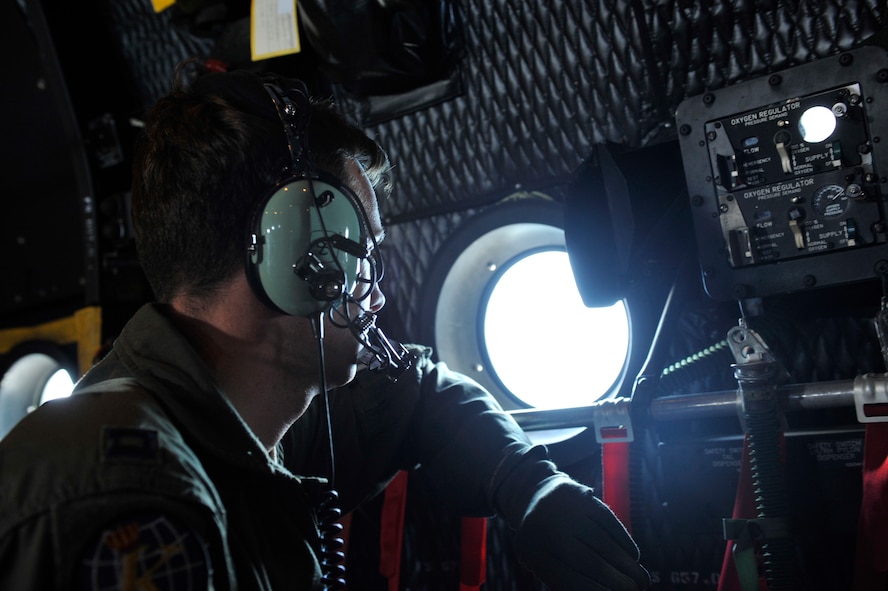MOODY AIR FORCE BASE, Ga. -- Capt. Jake Hess, 71st Rescue Squadron HC-130P/N Combat King co-pilot, scans the water as he searches for missing Haitian immigrants who had been reported missing in the Atlantic Ocean May 14. The aircrew and aircraft deployed from Moody to participate in the search and rescue mission and spent approximately 6 hours searching for the missing individuals. (U.S. Air Force photo by Senior Airman Schelli Jones)