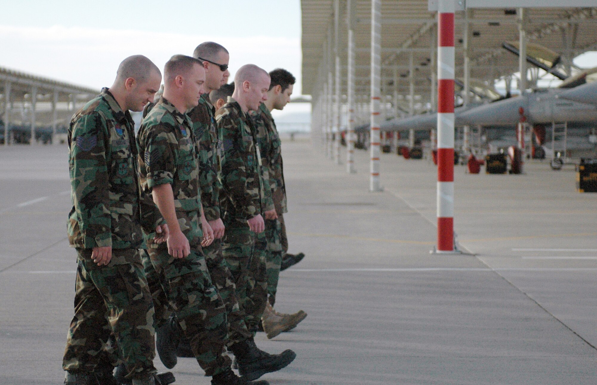 Members of the 162nd Maintenance Group propulsion section gather for a morning FOD walk on the flightline at Tucson International Airport. Members line up daily and walk in search of foreign object damage that can cause harm to aircraft. (Air National Guard photo by Tech. Sgt. Desiree Twombly)