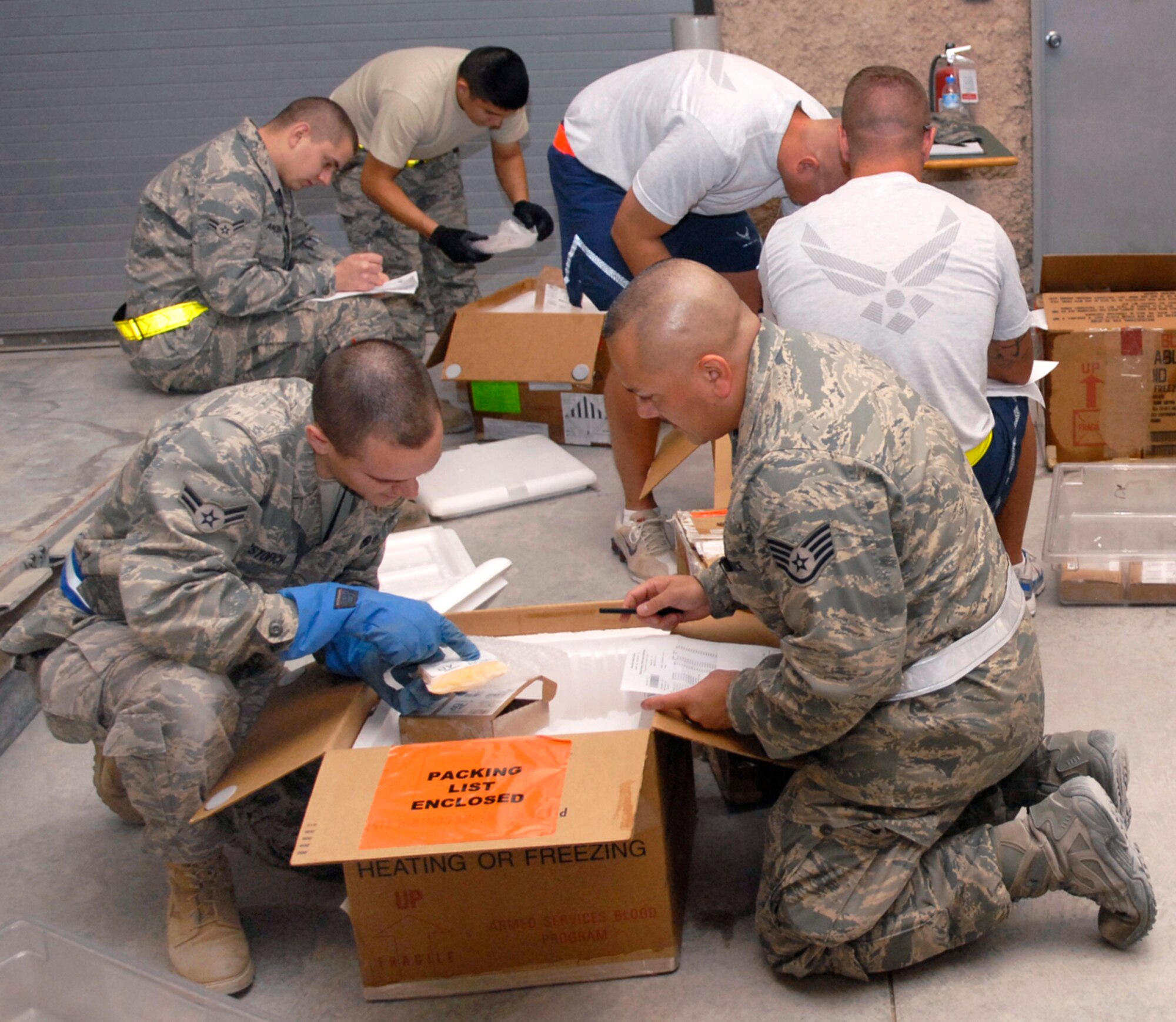 Volunteers at this air base in Southwest Asia assist the 379th Expeditionary Medical Group Blood Transshipment Center staff May 9 with inventorying incoming blood products to ensure they are ready to be distributed throughout the U.S. Central Command area of operation. (U.S. Air Force photo/Senior Airman Andrew Satran)