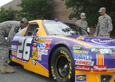 Chief Master Sgt. Reggie Bass, and Master Sgts. Judy Whidbee and John Rosati check out the NASCAR Crown Royal car in front of the Base Exchange here May 14. The car was shown at Charleston in support of a recent AAFES tour. These airmen are with Headquarters Air Force Reserve Command, Robins AFB, Ga.