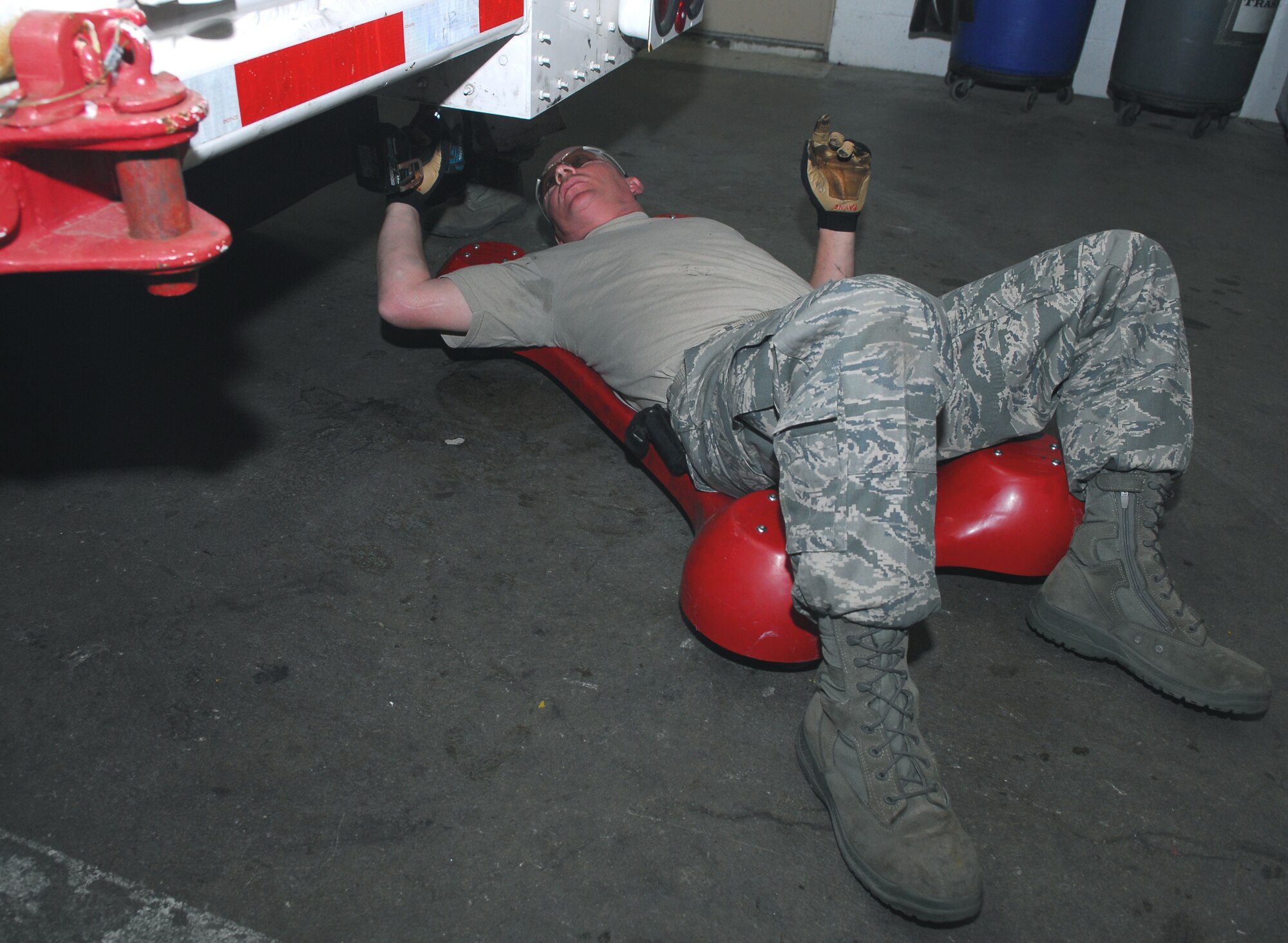 VANDENBERG AIR FORCE BASE, Calif. -- Wearing the proper safety gear, Staff Sgt. Jamie Payne of the 576th Flight Test Squadron reinstalls gear box covers to a payload transporter during an annual inspection here May 14. (U.S. Air Force photo/Senior Airman Christopher Hubenthal)