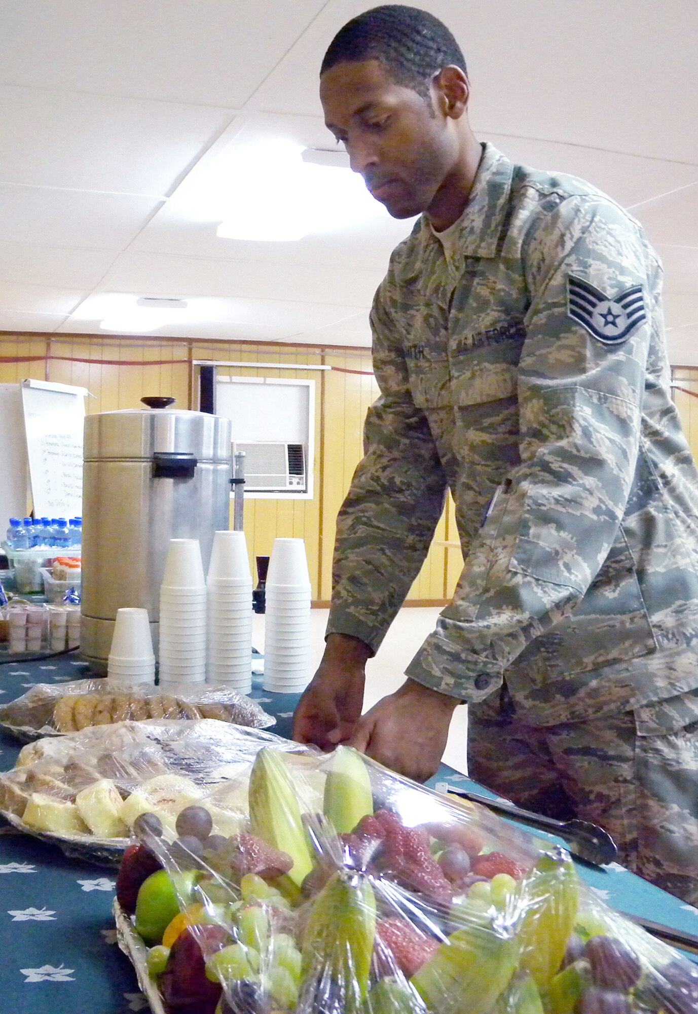 Staff Sgt. Michael Smith prepares a snack area for conference participants May 12 at the Freedom Conference Center at an undisclosed base in Southwest Asia. Sergeant Smith is a 379th Expeditionary Force Support Squadron assistant facility manager. (U.S. Air Force photo/Tech. Sgt. Shad Eidson)