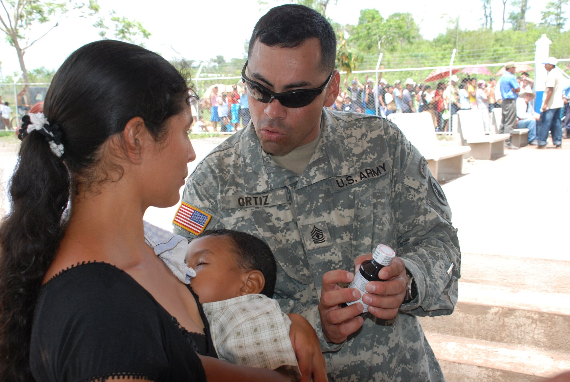 Army 1st Sgt. Jorge Ortiz, of Joint Task Force-Bravo’s Army Forces, explains the directions of a pharmacy technician to a woman seen during the task force’s medical readiness exercise here May 14 and 15.  Thirty-four Soldiers and Airmen participated in the exercise, including aviators, doctors, nurses, technicians, translators and administrators.  (U.S. Air Force photo/Tech. Sgt. Rebecca Danét)