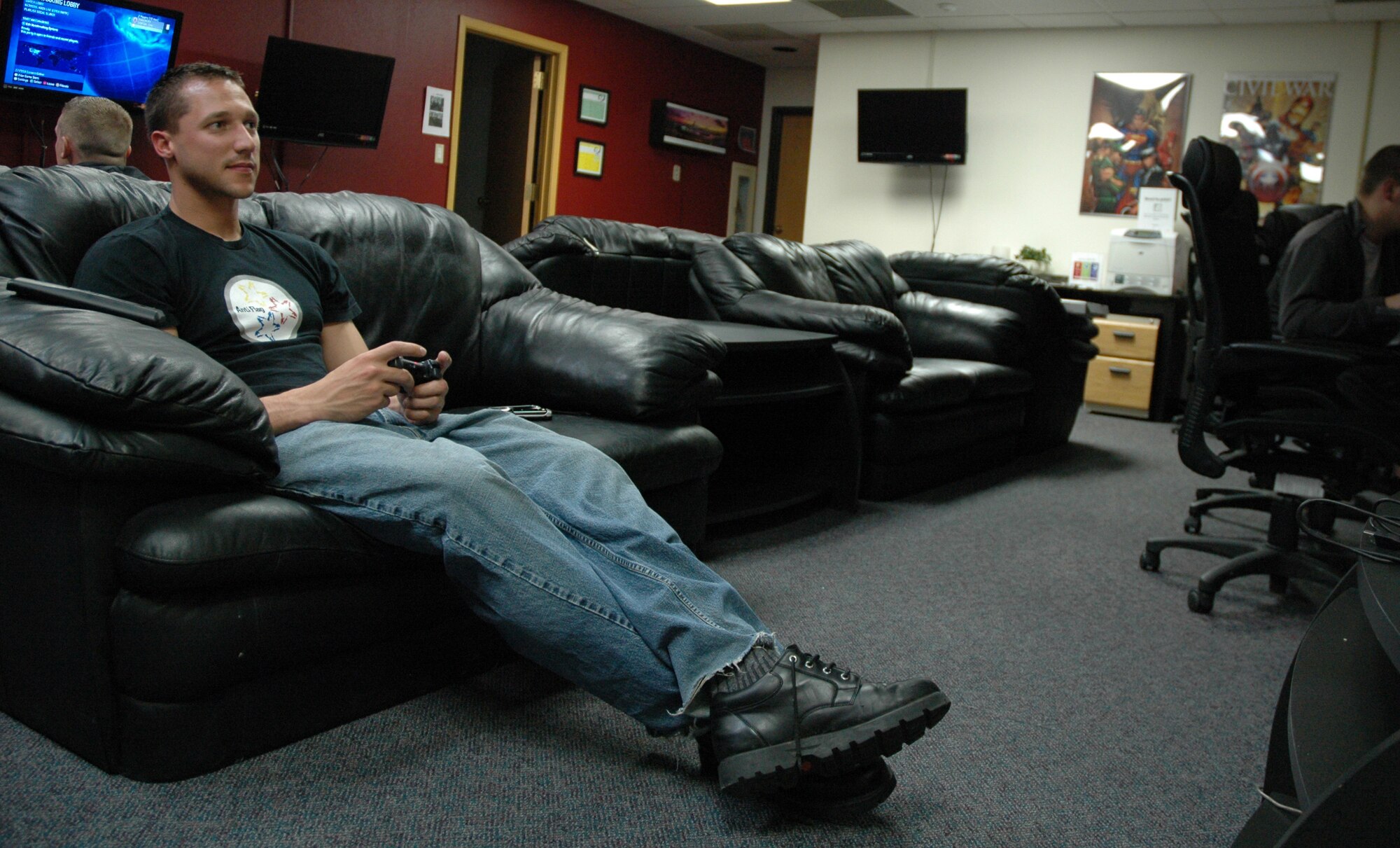 Airman 1st Class Douglas Maceiko, 819th RED HORSE Squadron pavement and construction equipment apprentice, plays video games while volunteering as a dispatcher for the Airmen Against Drunk Driving program May 9 at the Detour. (U.S. Air Force photo/Senior Airman Dillon White)