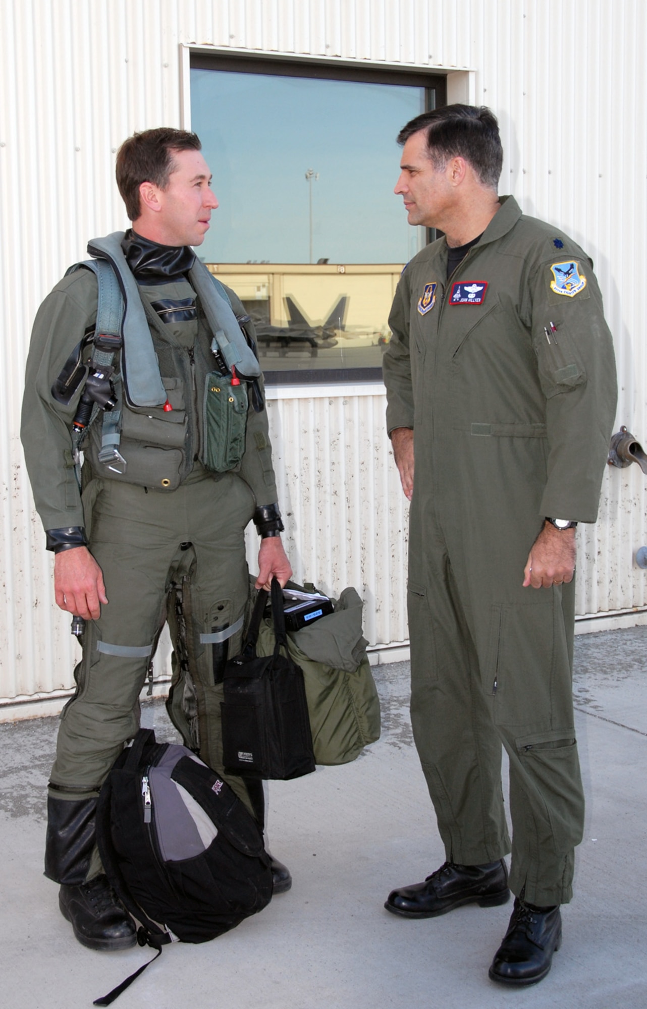 ELMENDORF AIR FORCE BASE, Alaska – Lt. Col. John Hillyer, Air Force Reserve Command’s 477th Fighter Group commander, talks with Maj. Chad “Motor” Feucht, 302nd Fighter Squadron, before the major deploys to Andersen Air Force Base, Guam, May 12. The fighter pilot and 11 other pilots are flying the Air Force’s newest fighter to the Pacific Theater, marking the F-22’s fifth and sixth deployments to the area. (U.S. Air Force photo/Staff Sgt. Andrea Knudson)
