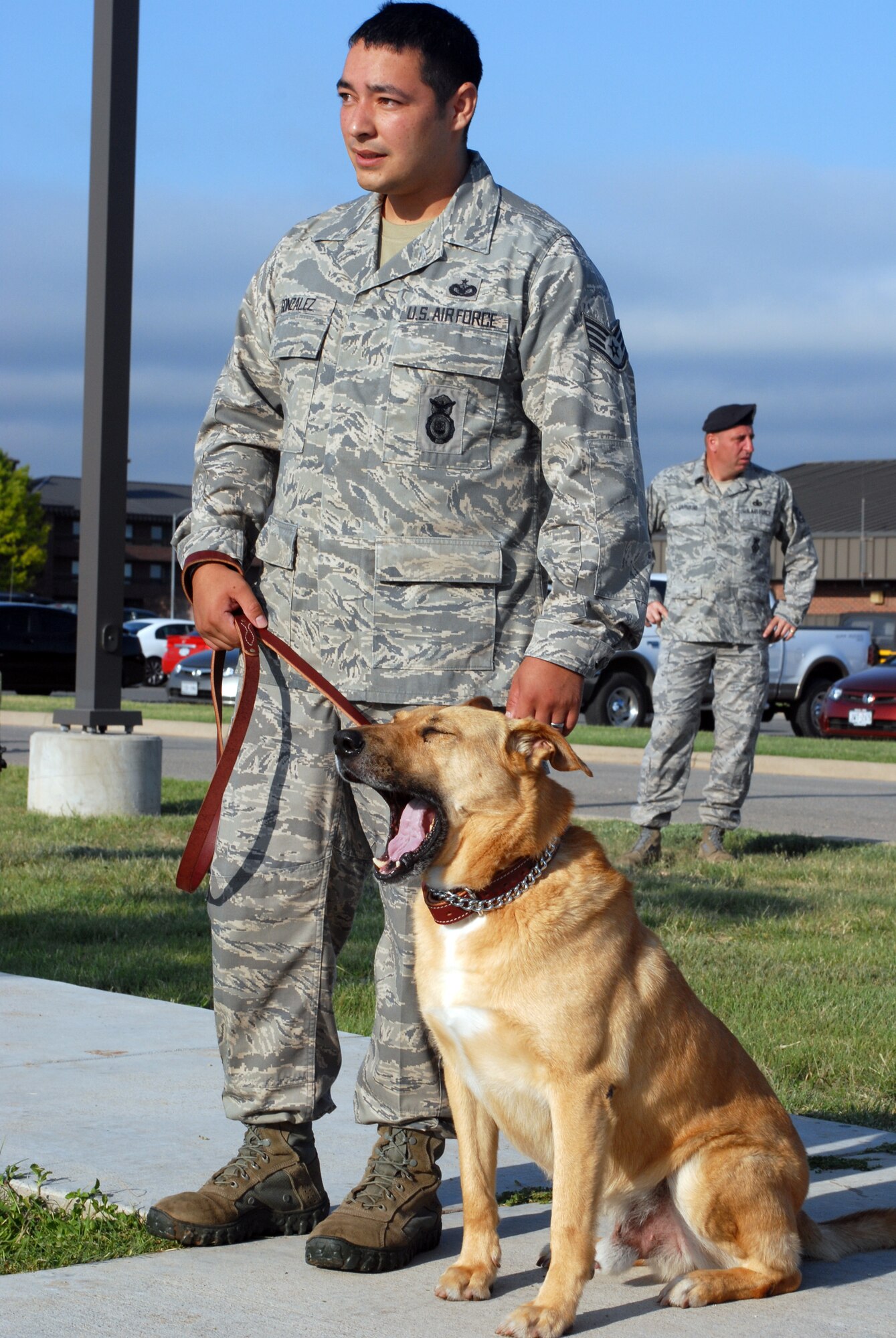 Expressing his opinion on the early start of the Drug Detection portion of the K-9 Competition May 12 is Bak H, a military working dog from Randolph Air Force Base, Texas, with his partner, Staff Sgt. Jesus Gonzalez. Sergeant Gonzalez and Bak H placed first in the Drug Detection event. (U.S. Air Force photo by Airman Clayton Lenhardt)