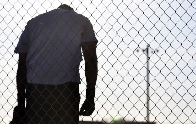 Duvale Brown stands on the center field warning track of softball field one waiting for another batter to finish hitting. A warning track is a section of dirt near the fence that warns outfielders when they are getting close to the fence.
