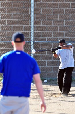 Duvale Brown connects with a pitch from Airman McMillen. Mr. Brown hit one home run in the first round and two home runs in the second round to win the event. The winner was determined by the most home runs hit in the second round.