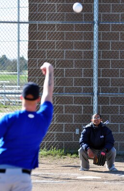 Airmen McMillen throws some practice pitches before the home run derby. Wind affected the ball during the tournament and made it difficult for the batters to hit home runs.