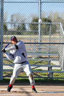 Staff Sgt. Ernie Luna, 790th Missile Security Forces Squadron, eyes a ball and gets ready to hit during the home run derby. Sergeant Luna hit five home runs in the first round of the tournament.