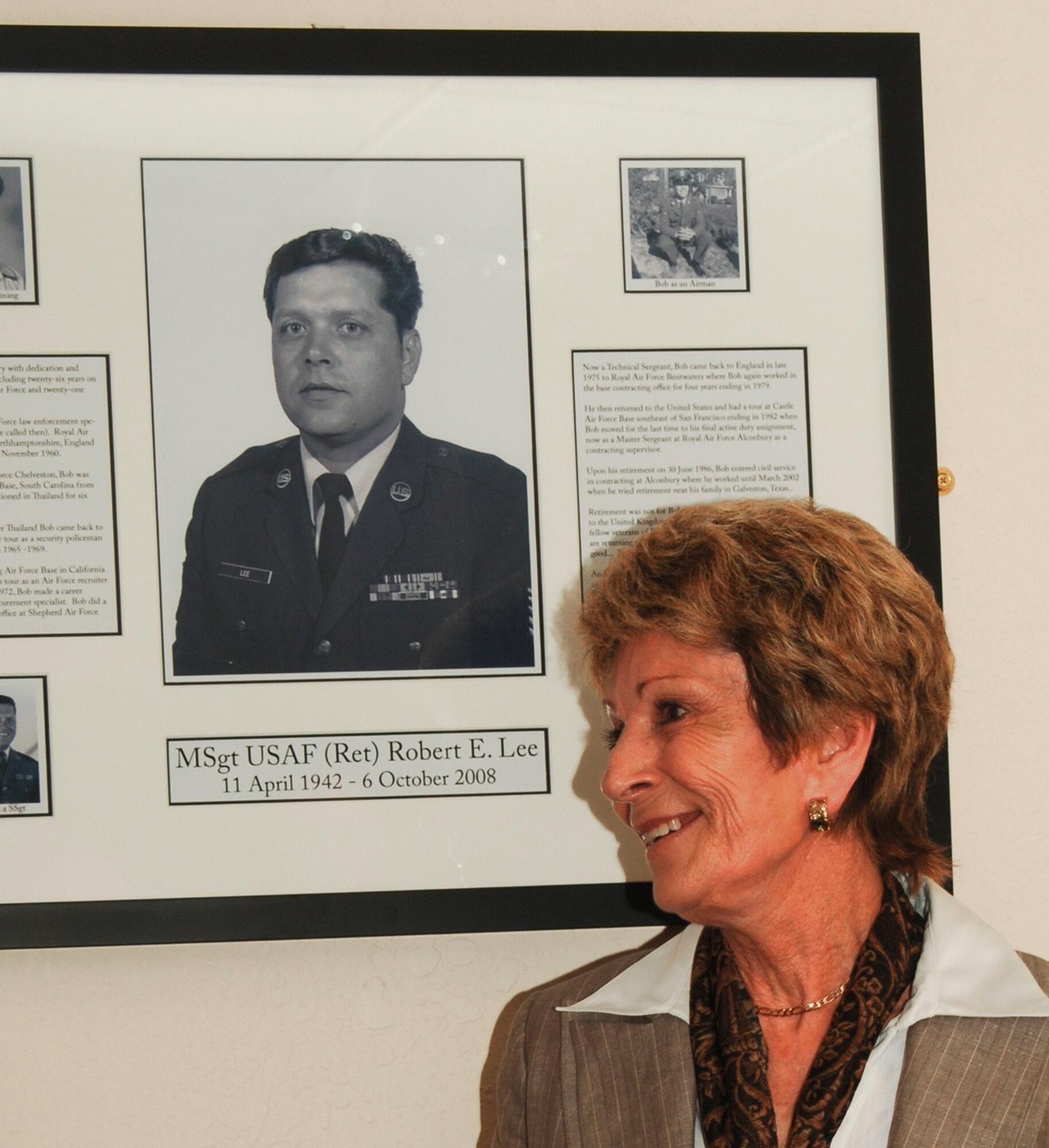 Mrs. Peggy Lee admires a photo montage honoring her late husband Robert E. "Bob" Lee in the "Bob Lee Memorial Conference Room" dedicated on May 15, 2009. Mr. Robert E. "Bob" Lee served as a purchasing agent at the JAC from 2003 until 2008 as part of a career of service to the nation spanning 26 years of service in the U.S. Air Force and 21 years of federal civil service. (U.S. Air Force photo by Staff Sgt. Chad E. Chisholm)