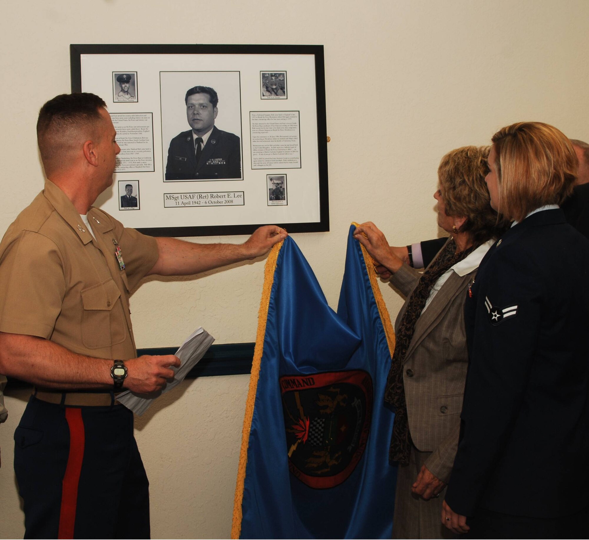JAC Commander, Marine Corps Colonel Pete Devlin joins Mrs. Peggy Lee and Mrs. Lee's  grandaughter, Airman First Class Courtney Lee as they unveil a tribute to the late Robert E. "Bob" Lee in the "Bob Lee Memorial Conference Room" dedicated on May 15, 2009. Mr. Robert E. "Bob" Lee served as a purchasing agent at the JAC from 2003 until 2008 as part of a career of service to the nation spanning 26 years of service in the U.S. Air Force and 21 years of federal civil service.  (U.S. Air Force photo by Staff Sgt. Chad E, Chisholm)
