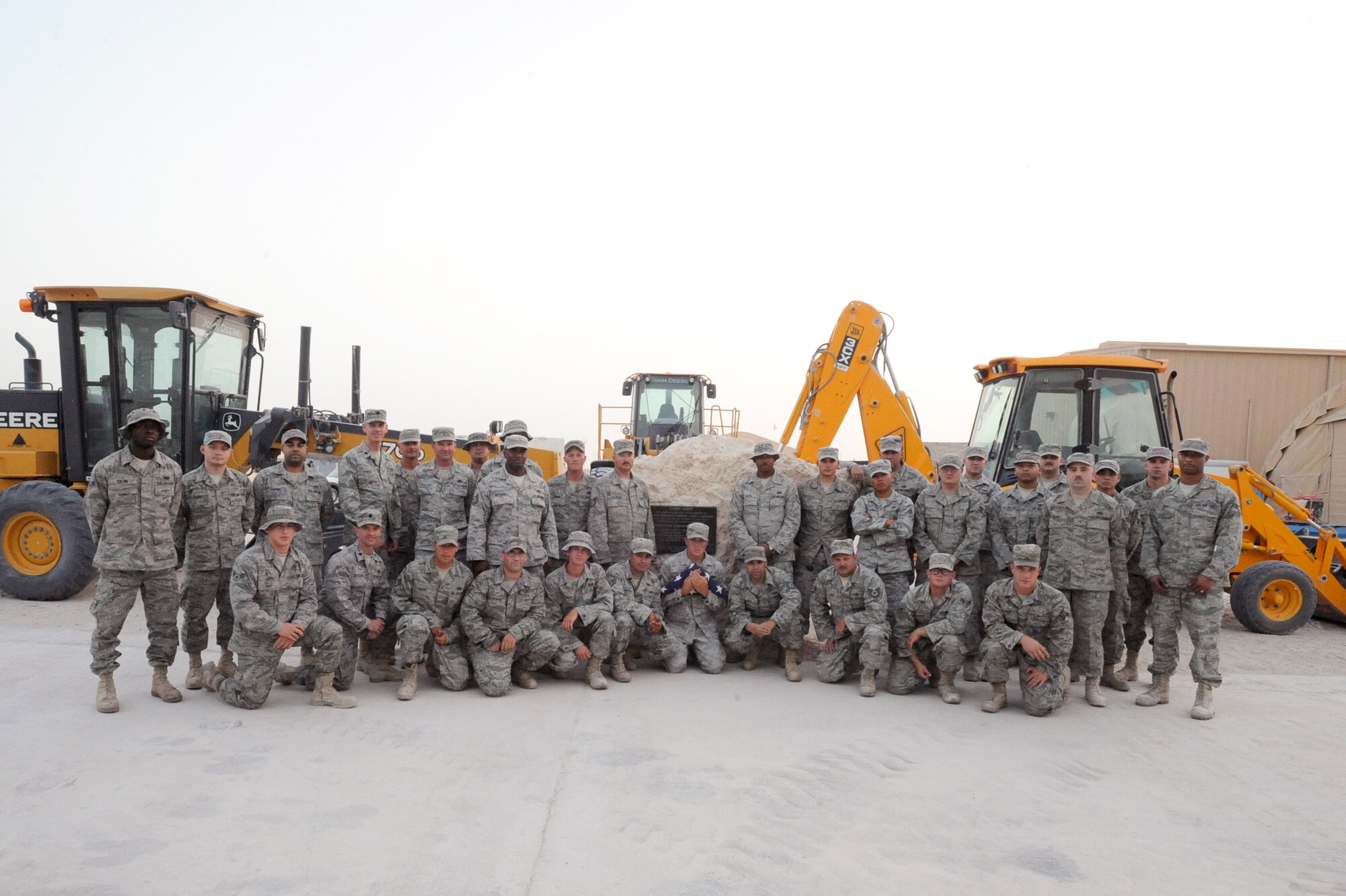 The Pavement and Equipment Flight better known as "Dirt Boyz" from the 379th Expeditionary Civil Engineer Squadron, pose in front of the memorial stone for Master Sgt. Evander E. "Andy" Andrews, after a memorial ceremony in his honor, May 15, 2009, in undisclosed location in Southwest Asia.  The memorial stone will be placed in front of the coalition compound movie theater and the theater will be renamed the Master Sgt. Evander E. "Andy" Andrews Memorial Theater once the stone is in its final resting place; Master Sgt. Andrews was Operation Enduring Freedom's first fatality.  All of the Dirt Boyz are deployed in support of Operations Iraqi and Enduring Freedom and Combined Joint Task Force - Horn of Africa. (U.S. Air Force Photo by Staff Sgt. Joshua Garcia/released)