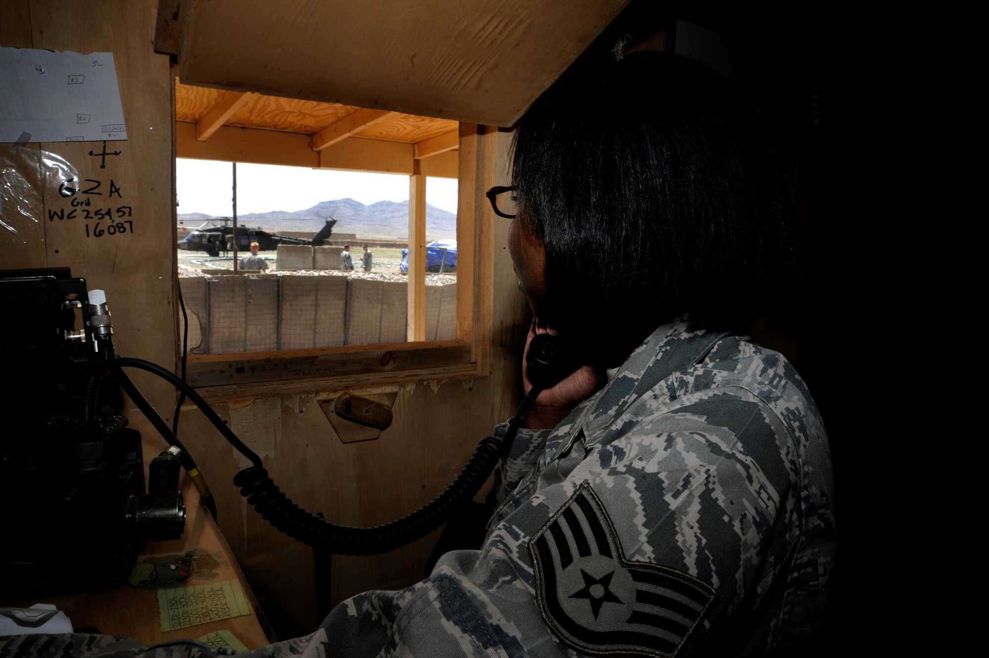 U.S. Air Force Staff Sgt. Benitra Colvin deployed to Afghanistan directs pilots of two UH-60 Black Hawks as they prepare to land at Forward Operating Base Gardez, Afghanistan, April 21, 2009. Due to manning shortfalls Sgt. Colvin who was originally assigned as a operations manager for the Paktya Provincial Reconstruction Team, has been requested to help with Air Traffic Control.  (U.S. Air Force photo by Staff Sgt. Shawn Weismiller)