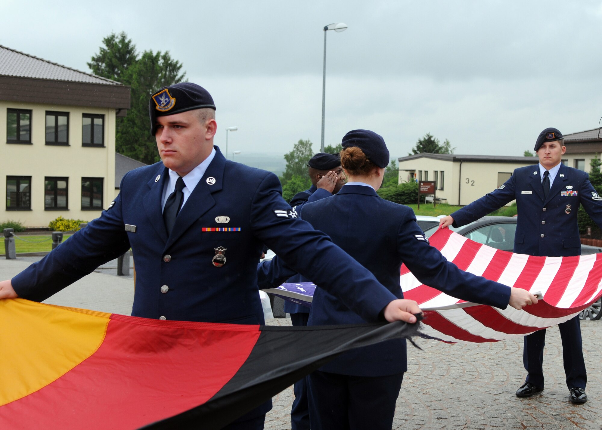 SPANGDAHLEM AIR BASE, Germany -- Members of the 52nd Security Forces Squadron fold both the German and American flag during a formal retreat ceremony May 15, 2009.  The 52nd SFS honored their fallen brethren during Police Week May 11-15.  (U.S. Air Force photo by Staff Sgt. Heather M. Norris)