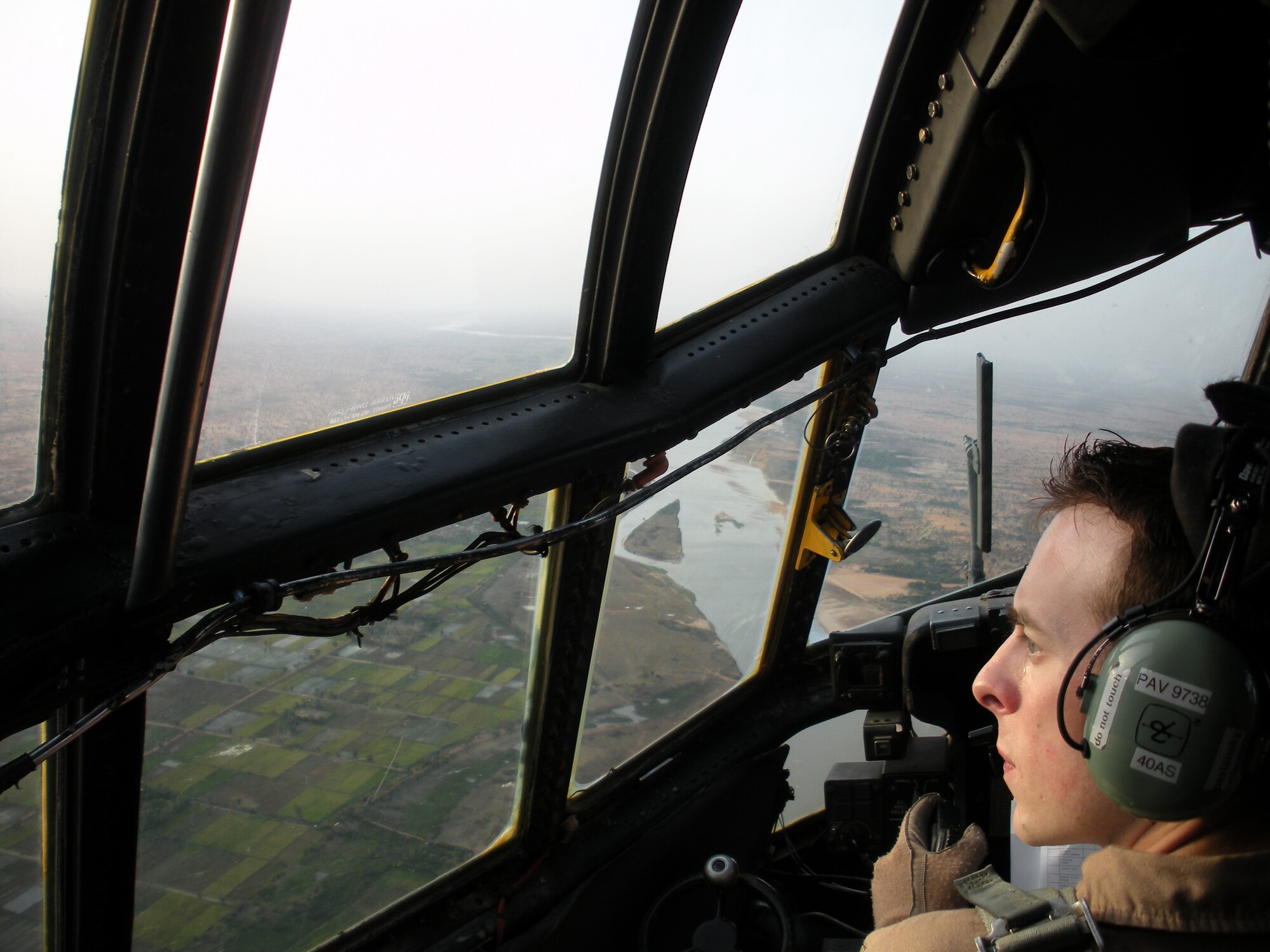 Capt. Jess Pavlansky, C-130H Aircraft Commander with the 17th Air Force’s 42nd Expeditionary Airlift Squadron, clears left over the Niger River while transporting several vehicles in support of humanitarian assistance efforts in Niamey, Niger May 6. (USAF Photo by Col. Robert Holba) 