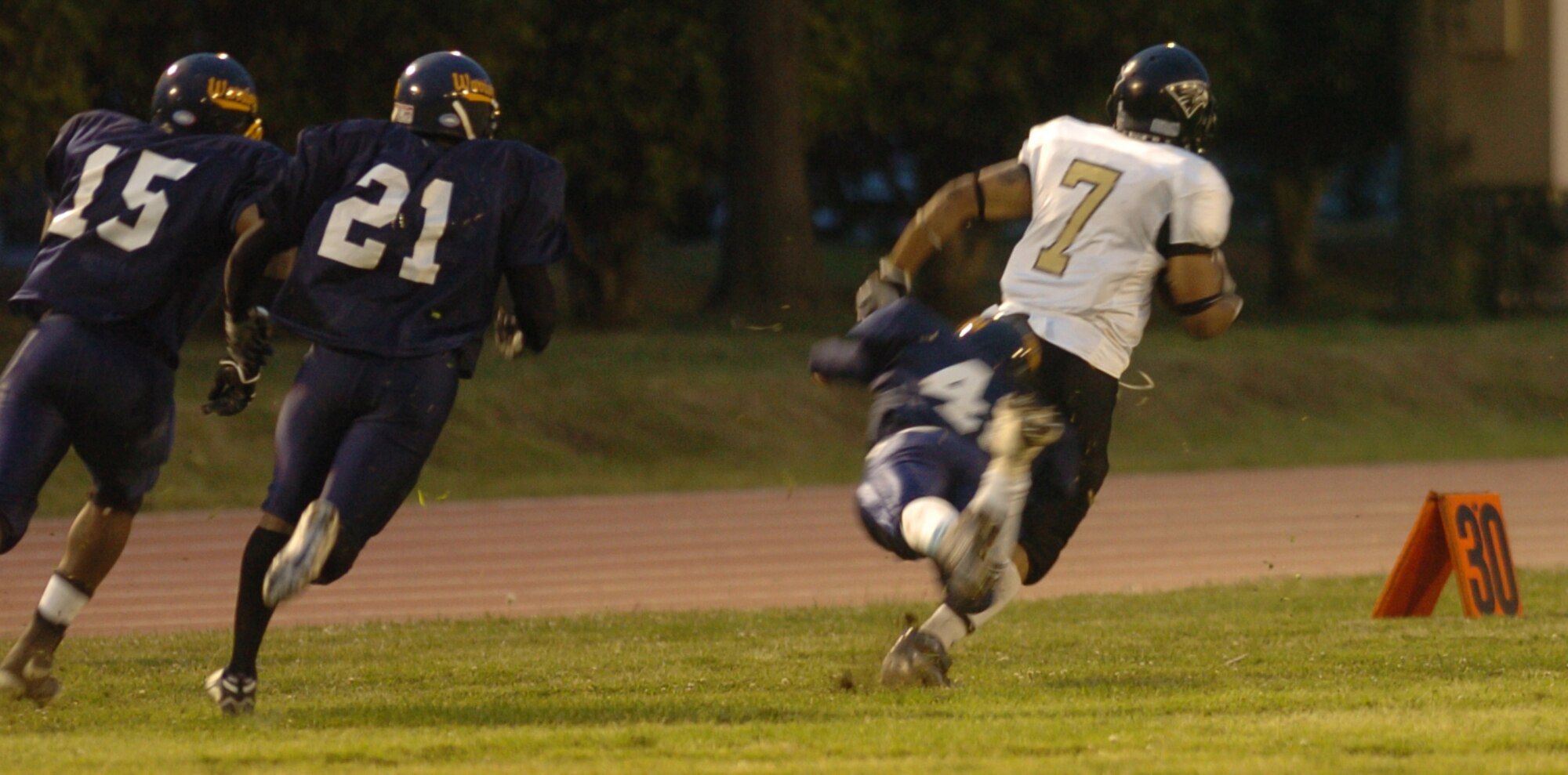 YOKOTA AIR BASE, Japan -- Yokosuka Seahawks' receiver Carl Harris outruns Yokota Warriors' defenders on his way to the endzone May 16 in Yokosuka's 28-25 victory in U.S. Forces Japan-American Football League action at Yokota's Bonk Field. The Warriors committed two turnovers in the final five minutes of the game to allow Yokosuka to rally for the win. Yokota's next home game is 6 p.m. May 22 vs. Torii Station from Okinawa. (U.S. Air Force photo/Master Sgt. Matt Summers)