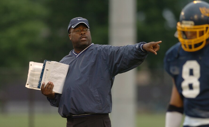 YOKOTA AIR BASE, Japan -- Yokota Warriors' head coach Herb Fletcher runs through offensive plays May 16 before a 28-25 loss to the Yokosuka Seahawks in U.S. Forces Japan-American Football League action at Yokota's Bonk Field. The Warriors committed two turnovers in the final five minutes of the game to allow Yokosuka to rally for the win. Yokota's next home game is 6 p.m. May 22 vs. Torii Station from Okinawa. (U.S. Air Force photo/Master Sgt. Matt Summers)
