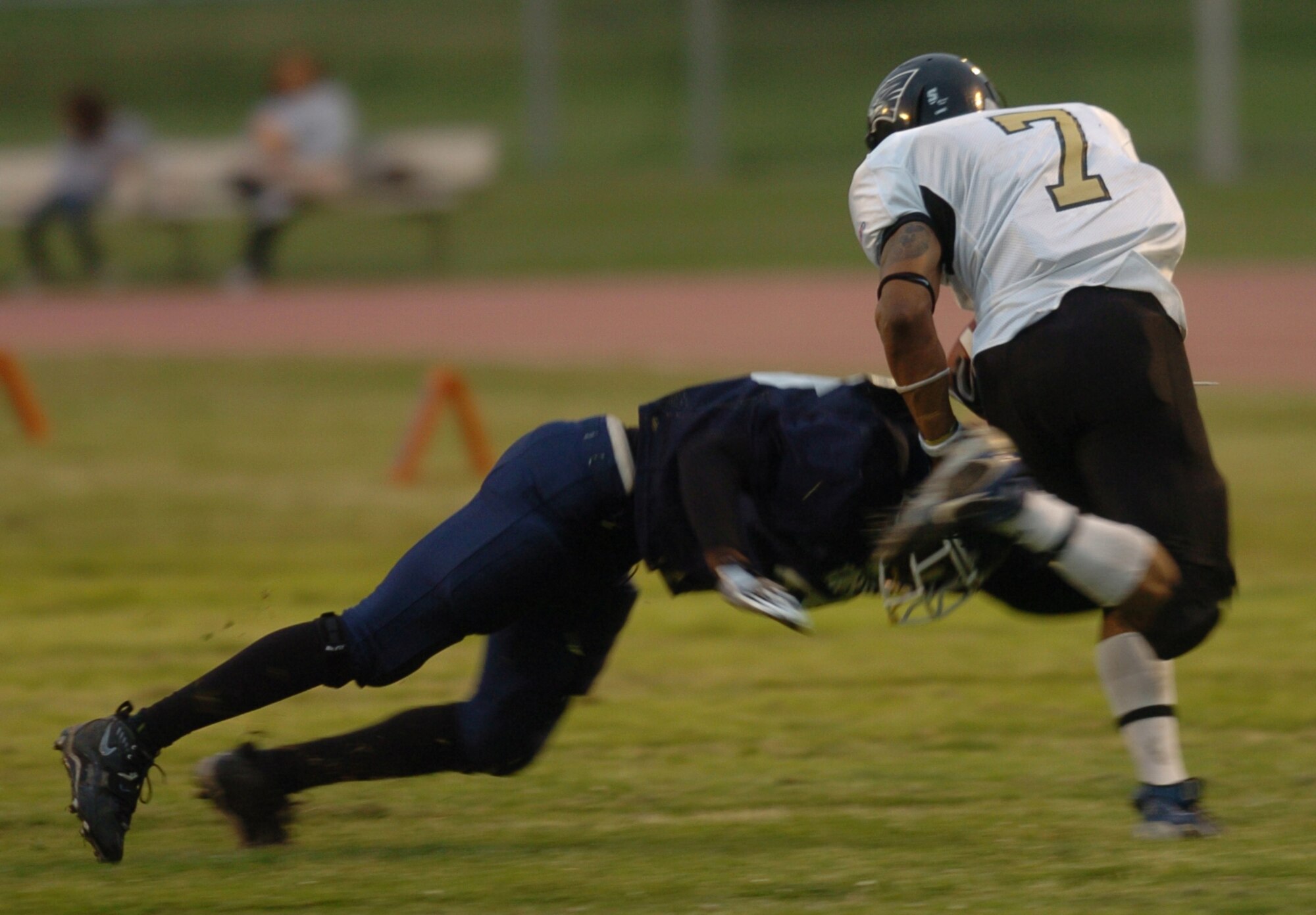 YOKOTA AIR BASE, Japan -- A Yokota Warriors' defender tries to make an open-field tackle on Yokosuka Seahawks' receiver Carl Harris May 16 in Yokosuka's 28-25 victory in U.S. Forces Japan-American Football League action at Yokota's Bonk Field. The Warriors committed two turnovers in the final five minutes of the game to allow Yokosuka to rally for the win. Yokota's next home game is 6 p.m. May 22 vs. Torii Station from Okinawa. (U.S. Air Force photo/Master Sgt. Matt Summers)