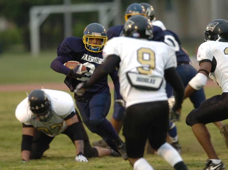 YOKOTA AIR BASE, Japan -- Yokota Warriors' receiver Dell Washington looks for running room May 16 in a 28-25 loss to the Yokosuka Seahawks in U.S. Forces Japan-American Football League action at Yokota's Bonk Field. The Warriors committed two turnovers in the final five minutes of the game to allow Yokosuka to rally for the win. Yokota's next home game is 6 p.m. May 22 vs. Torii Station from Okinawa. (U.S. Air Force photo/Master Sgt. Matt Summers)