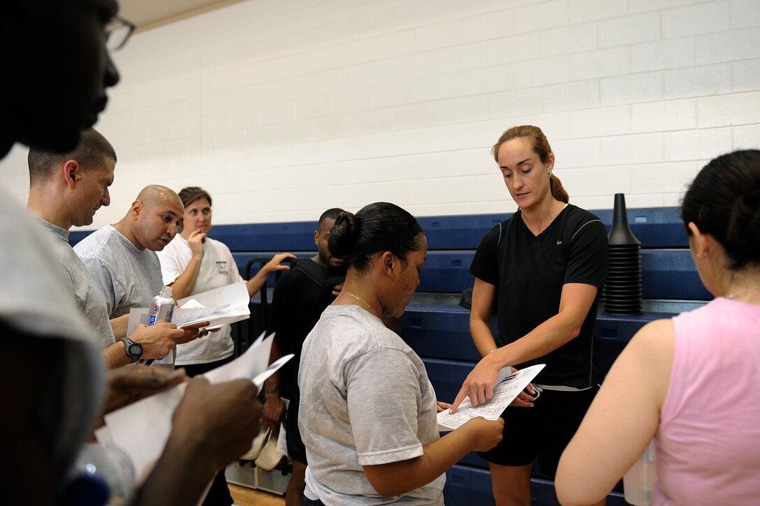 LANGLEY AIR FORCE BASE, Va. -- Ms. Katie Benick, Velocity Center director and manager, discusses personal fitness routines with Airmen who participated in the Velocity class here May 15.  Certified representatives from Velocity led a physical conditioning class geared toward improving overall physical performance.  (U.S. Air Force photo/Senior Airman Vernon Young)