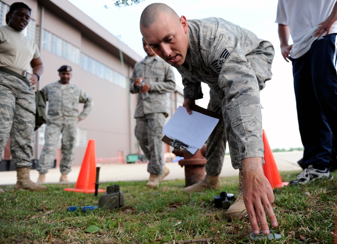 LANGLEY AIR FORCE BASE, Va. -- Tech. Sgt. Thomas Grubbs, 1st Security Forces Squadron Alpha flight chief, indentifies an item at the memory test station during the Strong Man Competition obstacle course, here May 15.  1st SFS Airmen and civilians divided into 4-man teams to complete the obstacle course designed to build physical endurance and unit cohesion during National Police Week.  (U.S. Air Force photo/Senior Airman Vernon Young)