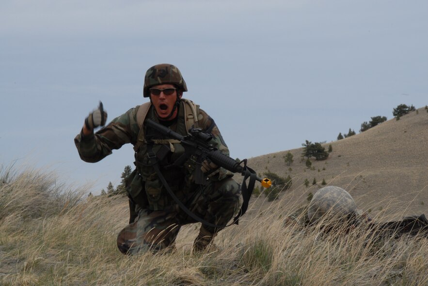 A Security Forces fire team leader, from the 185th Air Refueling Wing, Sioux City, Iowa directs his members to lay down covering fire for a Search and Rescue mission during operation Northern Thunder at Fort Harrison, Montana on 17 May 2009.  (US Air Force photo by TSgt Brian Cox)