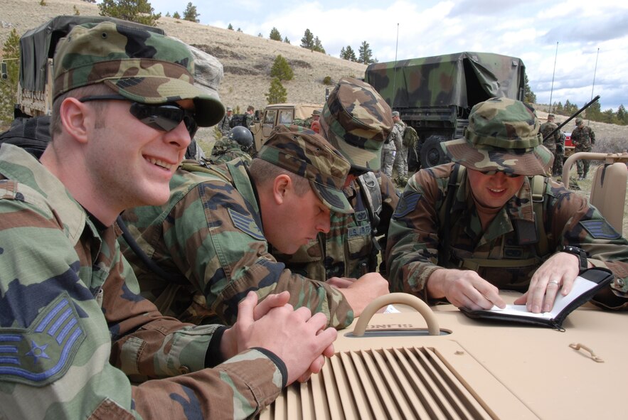 Members of the 185th Air Refueling Wing, Security Forces, from Sioux City, Iowa prepare for the final portion of land navigation training at Fort Harrison, Montana during operation Northern Thunder on 14 May 2009.  Ten fire teams of four to five troops each must traverse an average of 15 kilometers over steep topography and reach five specific locations in less than six hours to pass.   (US Air Force photo by TSgt Brian Cox)