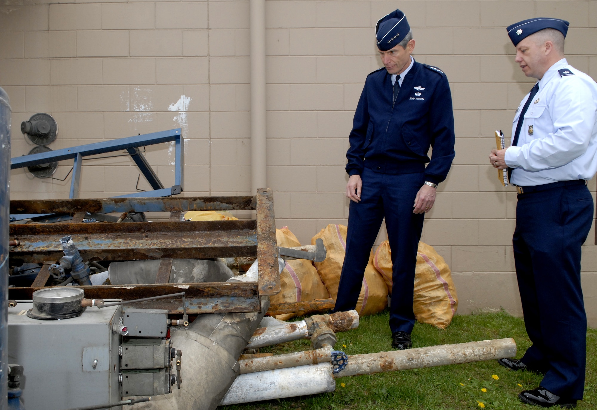 Air Force Chief of Staff Gen. Norton A. Schwartz observes the corroded water pipes recently removed due to pipes bursting in a senior NCO dorm at Osan AB.  The dorm like many Osan facilities have not been renovated in over 20 years.