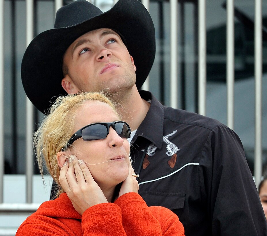 U.S. Air Force Tech. Sgt. Cindy Haught, and U.S. Army Cpl. Chris Leonard watch the aerial demonstrations at the 2009 Joint Service Open Houseon Andrews Air Force Base, Md., May 16, 2009. 