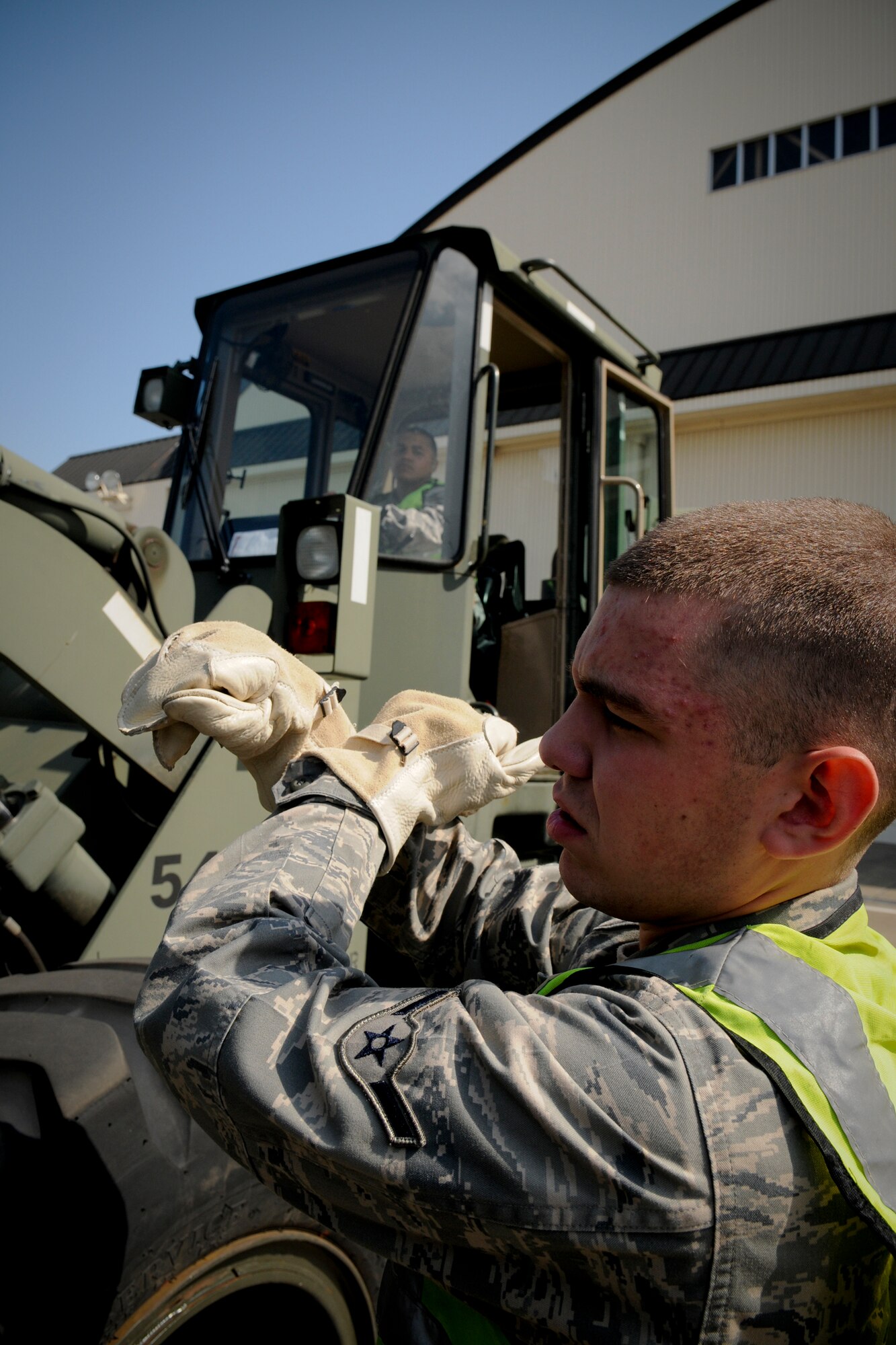 MISAWA AIR BASE, Japan -- Airman Kiernan Box, 35th Civil Engineer Squadron utilities flight, marshals cargo lifting during an initial response readiness exercise May 18, 2009. The exercise tested the base's ability to quickly deploy jets and personnel during heightened threat levels. (U.S. Air Force photo by Senior Airman Jamal D. Sutter)