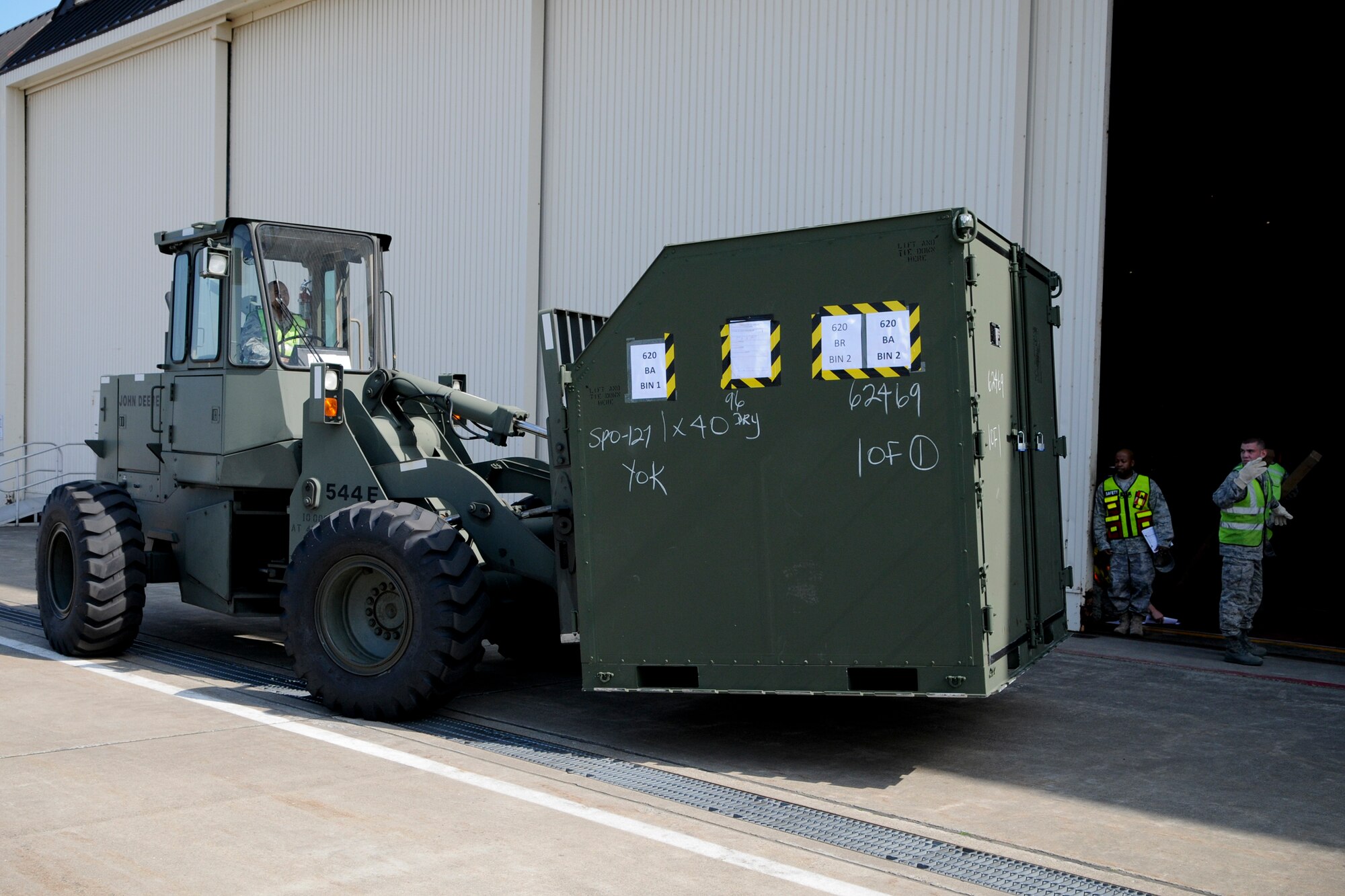 MISAWA AIR BASE, Japan -- Airmen prepare to load cargo at Hangar 949 during an initial response readiness exercise May 18, 2009. The exercise tested the base's ability to quickly deploy jets and personnel during heightened threat levels. (U.S. Air Force photo by Senior Airman Jamal D. Sutter)