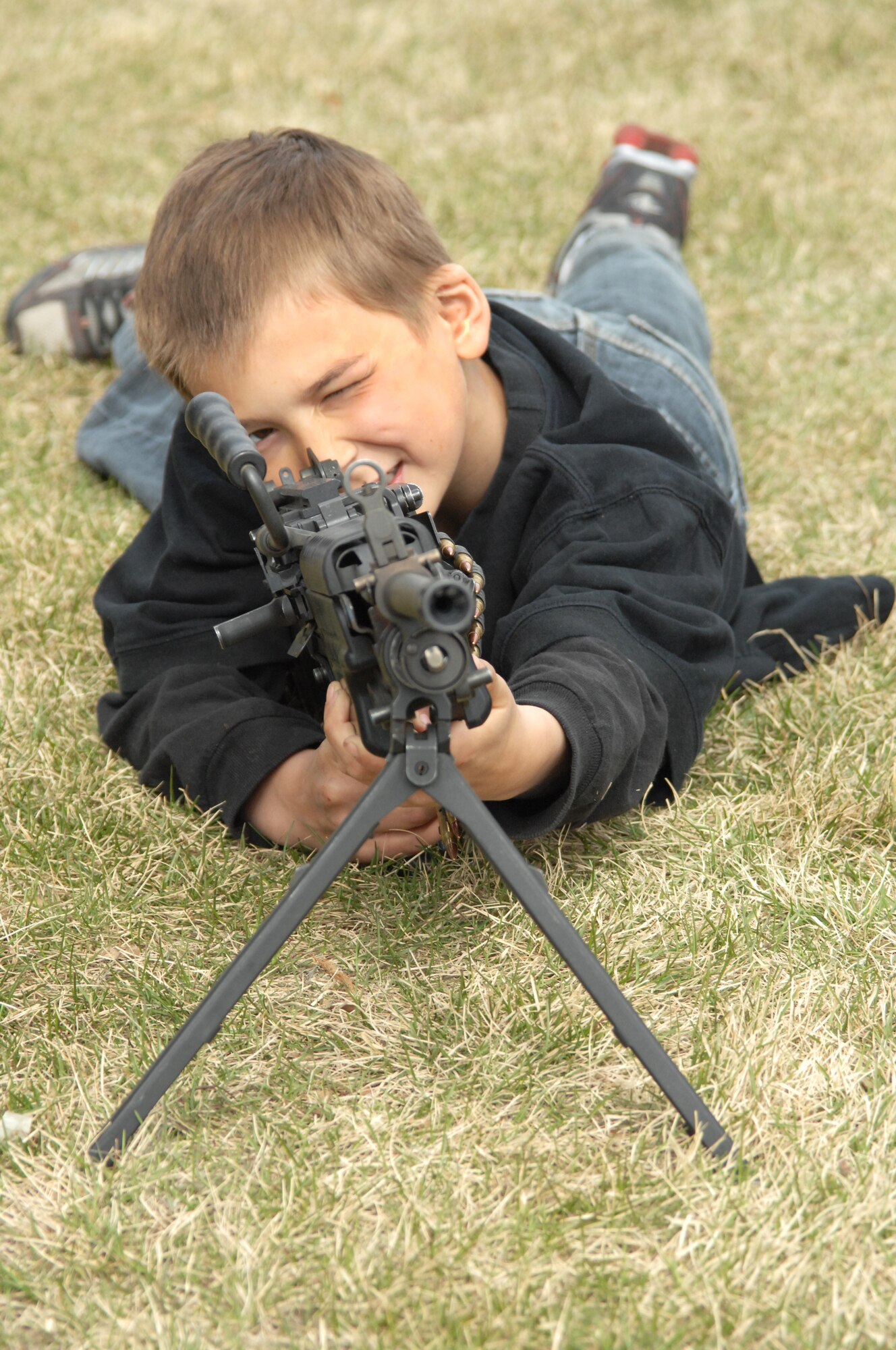 Aaron Mason peers down the sights of an M249 during a demonstration for the 354th Security Forces Squadron Police Week weapons demonstration May 15, 2009, Eielson Air Force Base, Alaska. Police Week events included a police vehicle and weapons display and a free cook out for the Eielson community. Aaron is the son of Staff Sgt. Jack Mason, 354th Maintenance Squadron Jet Engine Intermediate Maintenance NCOIC.