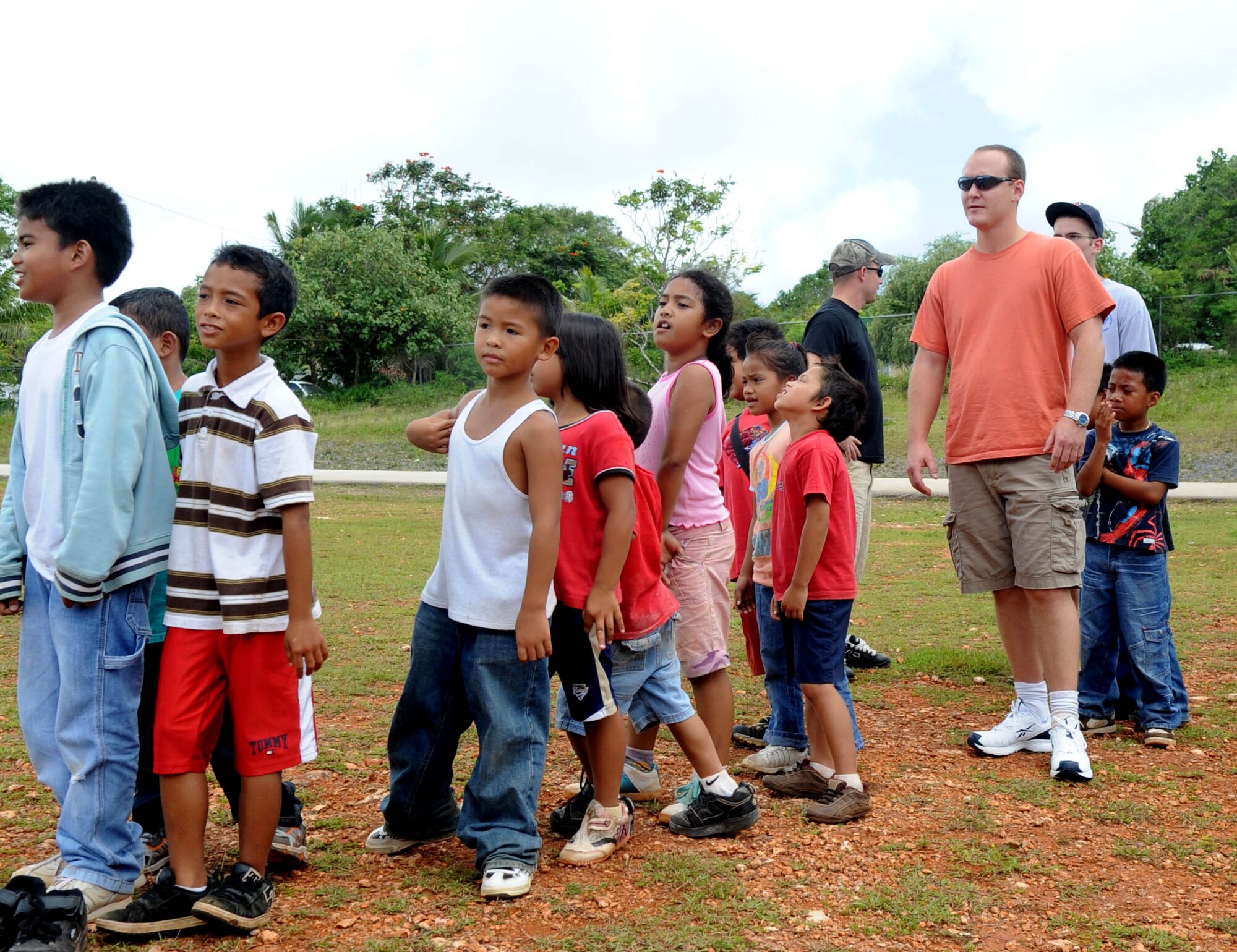 AGANA, Guam -- Staff Sgt. Landon D. Scheer, 509th Expeditionary Aircraft Maintenance Unit B-2 Spirit crew chief, waits in line on the playground during a game of kickball at Machananao Elementary School.  The Wendell, Idaho, native is deployed to Andersen Air Force Base, Guam, from Whiteman AFB, Mo.  (U.S. Air Force photo by Senior Airman Christopher Bush)