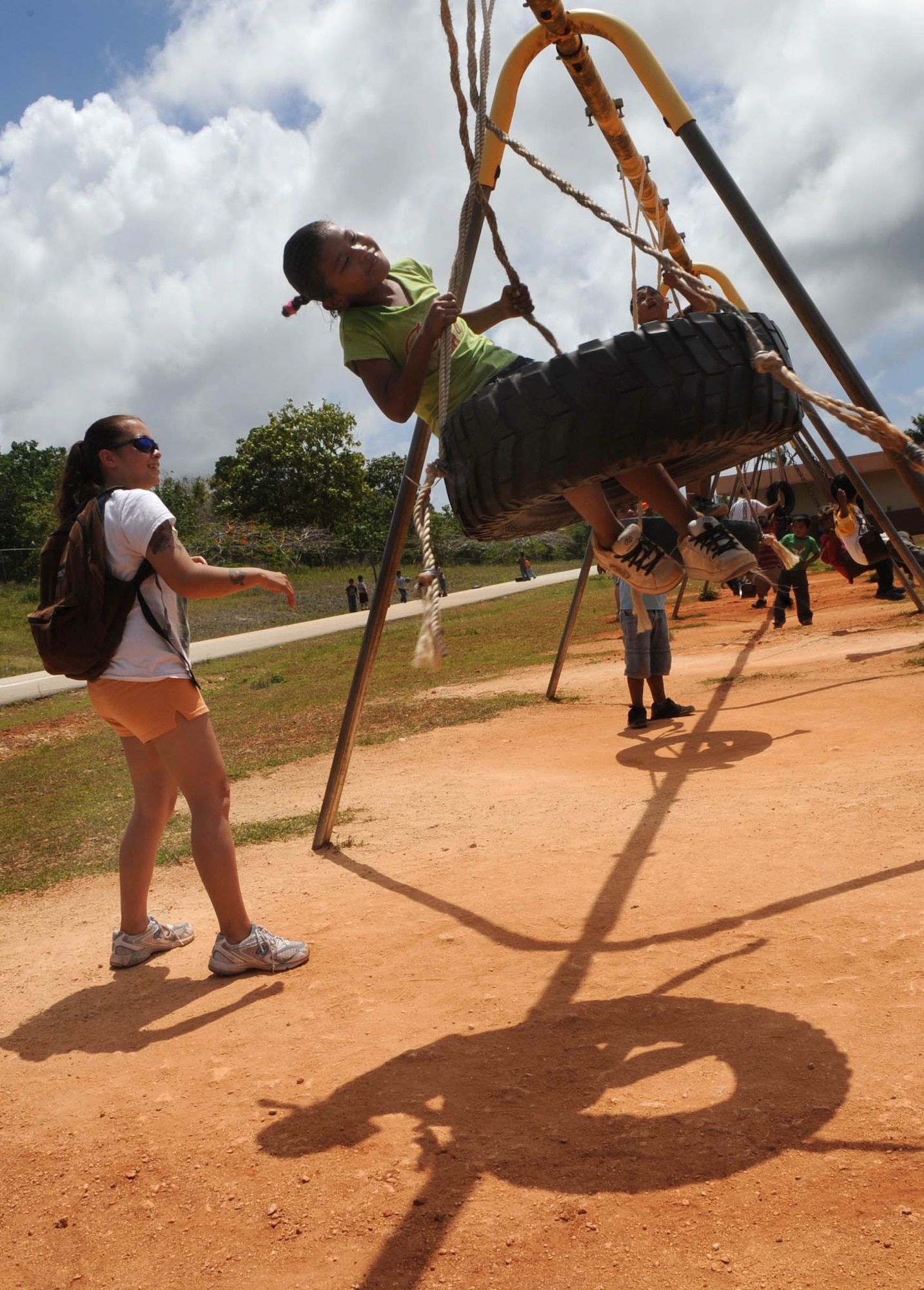 AGANA, Guam – Airman 1st Class Michelle E. Jaquith, 3rd Expeditionary Aircraft Maintenance Unit weapons load crew member, spins Endrose Ifraim, 7, second grader, on the playground at Machananao Elementary School.  Airman Jaquith is a Summerville, S.C., native deployed to Andersen Air Force Base, Guam, from Elmendorf AFB, Alaska.  (U.S. Air Force photo by Senior Airman Christopher Bush)