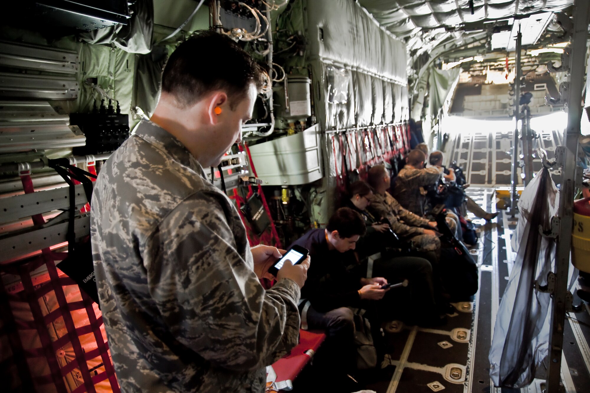 Major Chad Gibson, chief of Public Affairs, "tweets" about the Air Force's first-ever media day flight for internet bloggers as participants blog in the background. Bloggers from across the nation flew on the WC-130J Hurricane Hunter aircraft, learning about the Reserve weather mission. This pioneering event was the first of many hosted by the 403rd Wing focused on new media.