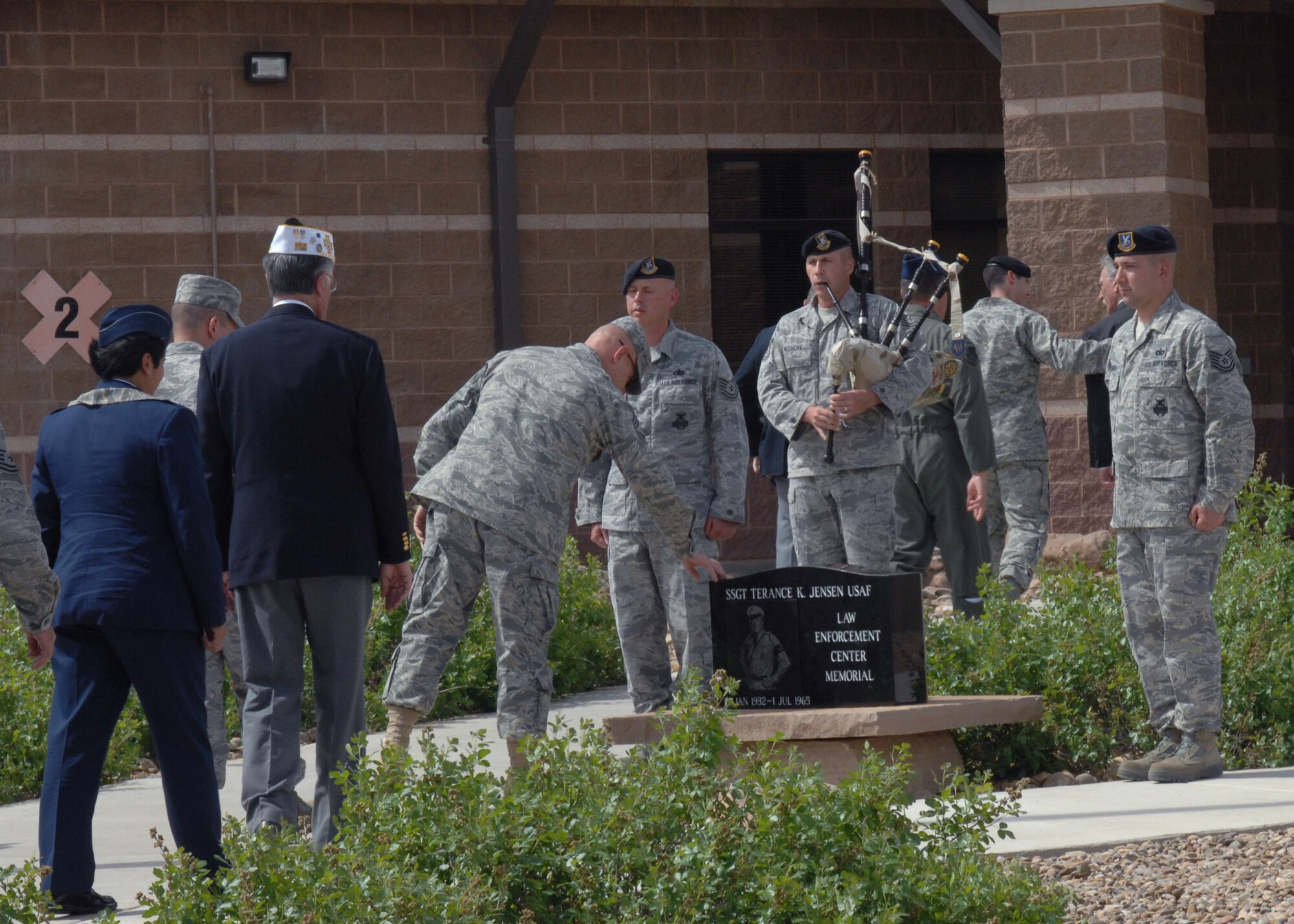 CANNON AIR FORCE BASE, N.M. -- Chief Master Sgt. Daniel Fischer, 27th Special Operations Wing command chief, pays his respects to Staff Sgt. Terance Jensen memorial May 15.  Air Commandos can view the memorial as they walk into the Security Forces building.  (U.S. Air Force photo/Airman 1st Class James Bell) 