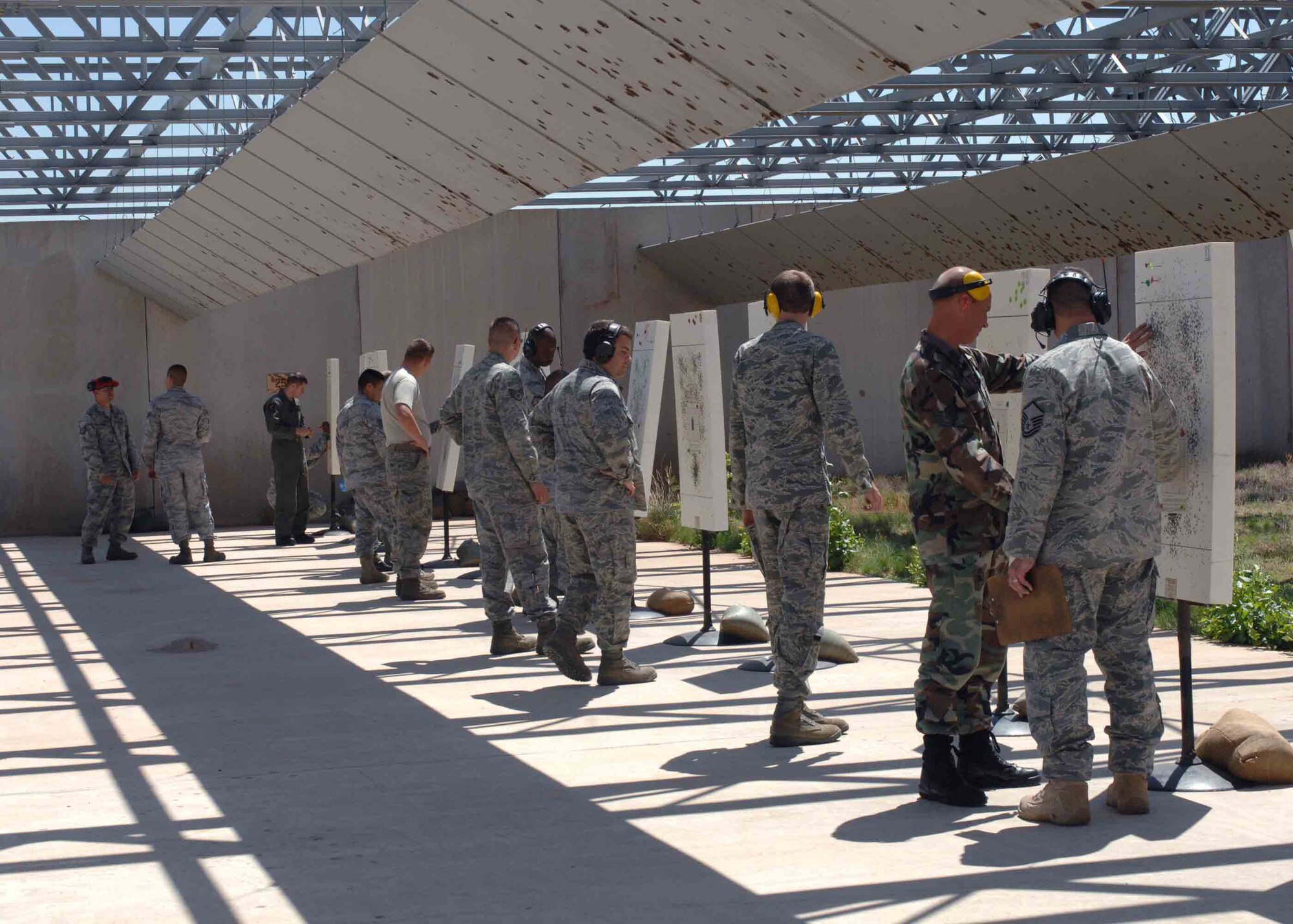 CANNON AIR FORCE BASE, N.M. -- Combat Arms instructors score target sheets at the base firing range May 12. To earn a bronze excellence in competition medal a shooter must score at least a 455. (U.S. Air Force photo/Airman 1st Class James Bell) 