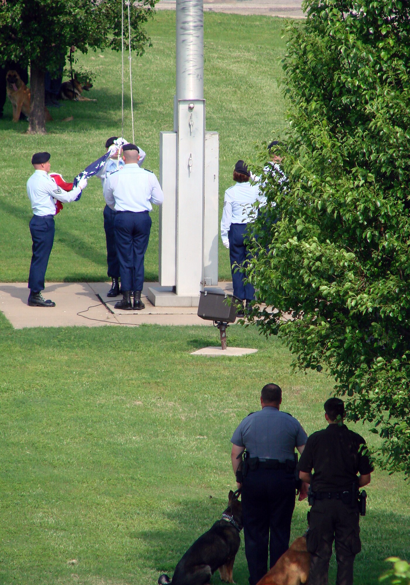 Dog handlers from local law enforcement agencies participate in a retreat ceremony held on base May 15 in honor of Peace Officers Memorial Day, part of National Police Week. A detail from the 71st Security Forces Squadron performed the flag folding. Attending the retreat were members of Oklahoma police departments from Enid, Fairfax and Blackwell, the Garfield Country Sheriff’s Department and the Department of Corrections. (U.S. Air Force photo/Joe B. Wiles)