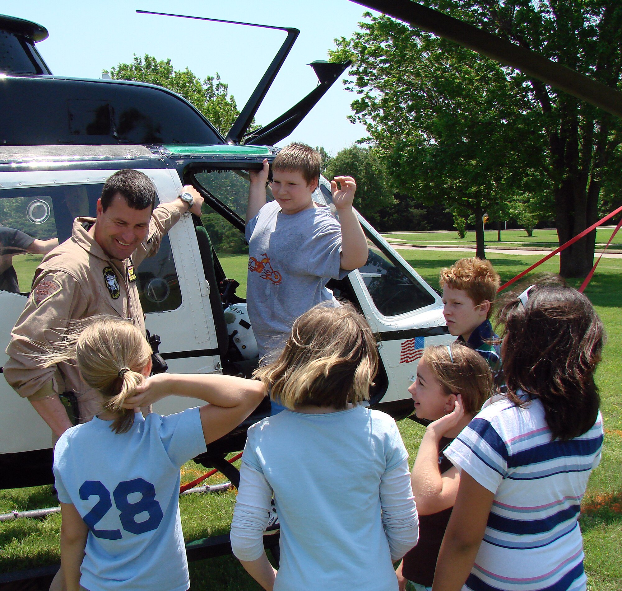Oklahoma Highway Patrol Trooper John Girtin explains the Bell OH-58 helicopter he flies for the OHP to students from Eisenhower Elementary School at Vance, during a Cops-for-Kids outing May 15 on base. The outing was one of several events the 71st Security Forces Squadron hosted during National Police Week. (U.S. Air Force photo/Joe B. Wiles)