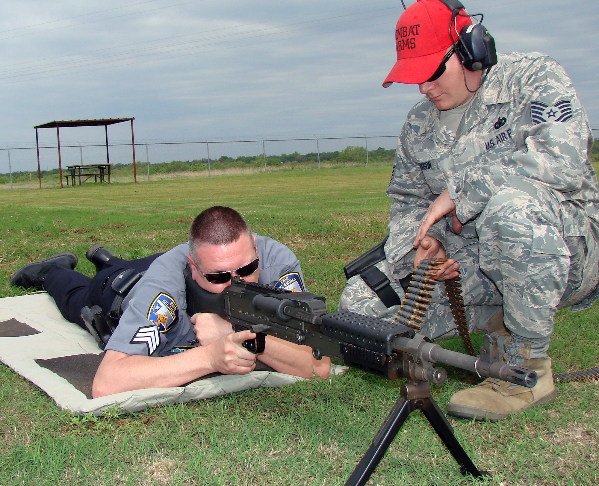 Sgt. Warren Wilson, left, with the Enid Police Department’s Special Weapons and Tactics team, fires an Air Force 240B small machine gun while Vance’s Tech. Sgt. Richard Dodson, a small arms instructor with the 71st Security Forces Squadron, feeds the ammo belt. The men were participating in a fun-shoot at the Enid PD firing range May 14, one of several events the 71st SFS hosted during National Police Week. (U.S. Air Force photo/Joe B. Wiles)