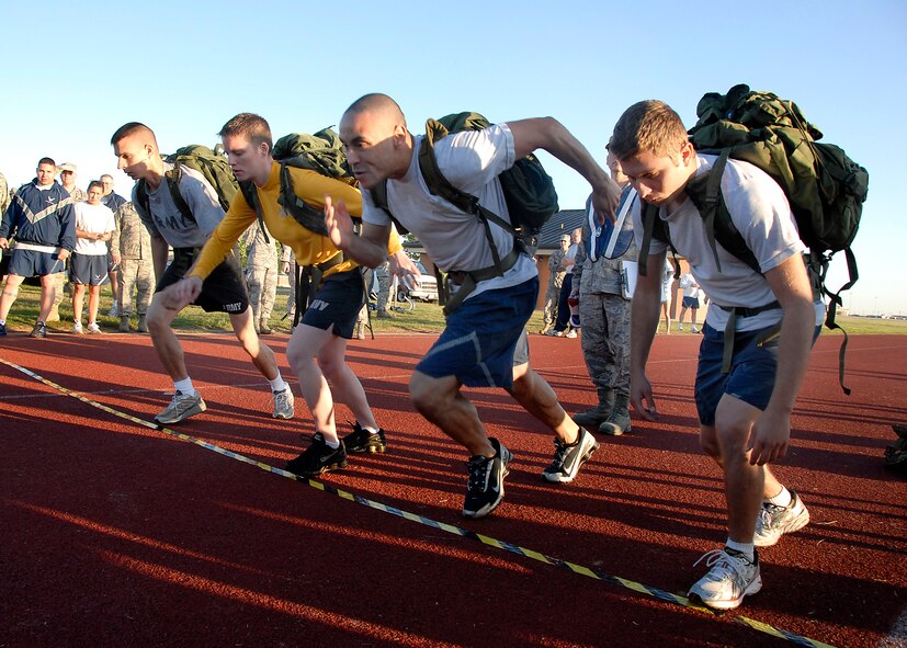 Contestants in the Rucksack relay start their quarter-mile stretch in a two-mile race May 19 kicking off the inaugural Wing Warrior Challenge. Participants in the event came from all groups on base as well as Army and Navy personnel. (U.S. Air Force photo/ Mike Litteken)