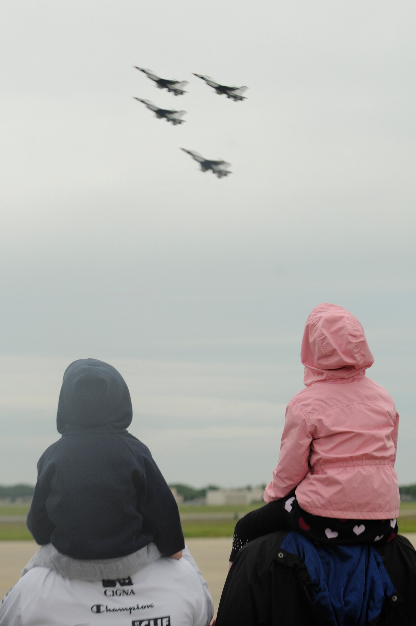 Spectators of all ages enjoy the show as the U.S. Air Force Thunderbirds fly past, May 17 during the 2009 Joint Service Open House at Andrews Air Force Base, Md. More than 150,000 people attended the three-day event that offered an opportunity for service members to meet and thank the public for their support and to show them America's skilled military. (U.S. Air Force photo by Senior Airman Tim Chacon)